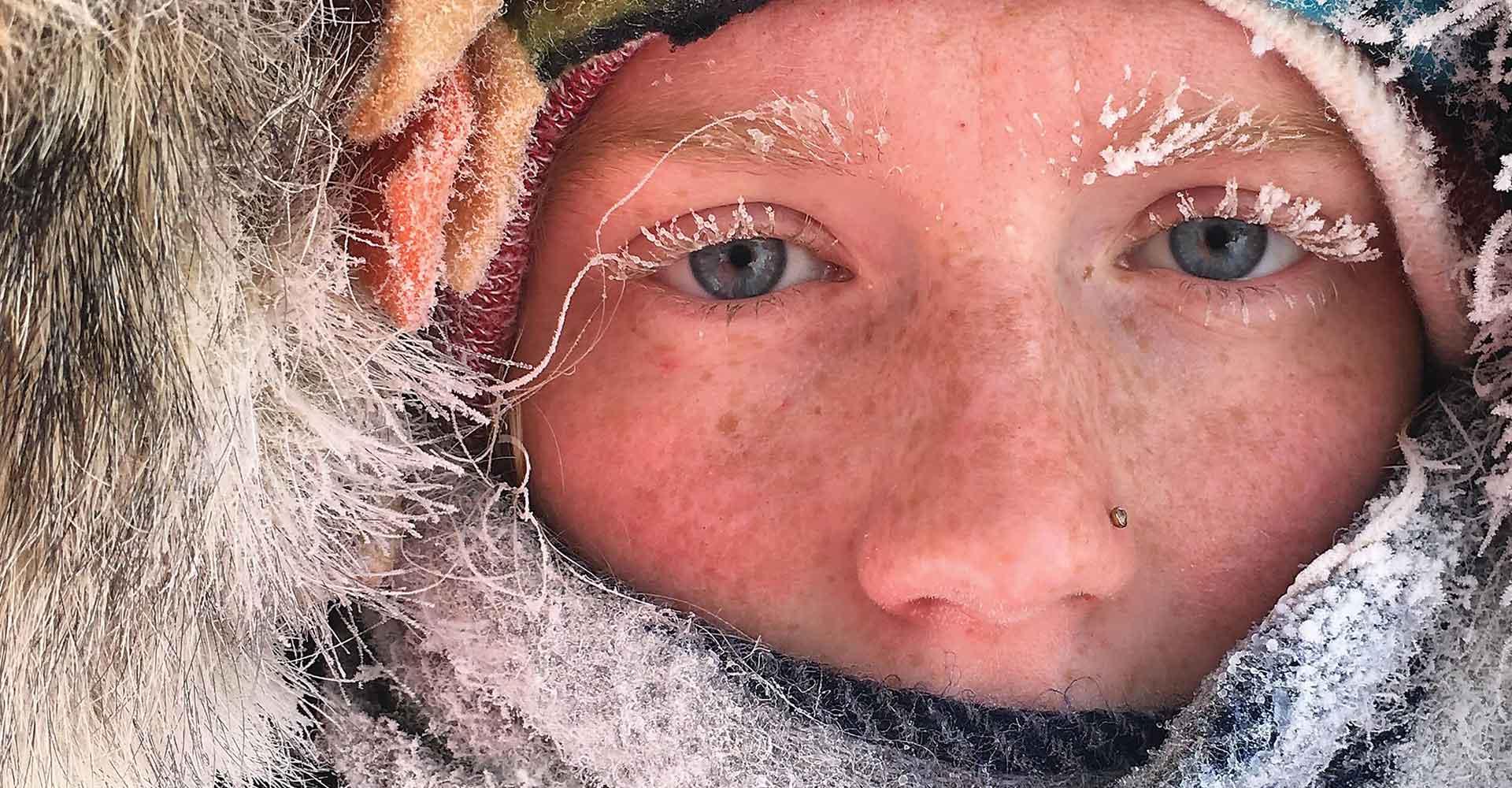 关闭 up of Agnes Scott Summit student's face, in a parka with frost on their eyelashes.
